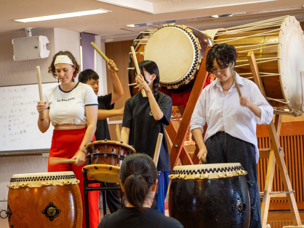 iCLA students try Taiko with Nirasaki Technical High School students.