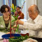 The Flower Arrangement instructor shows an iCLA student how to arrange the flowers.