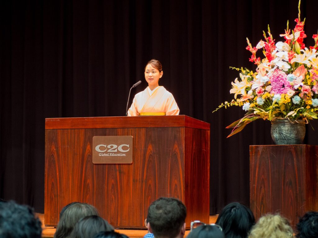 Yamanashi Gakuin University's President Takako Aoyama gives her welcome speech to new students at the Memorial Hall for the Fall 2024 Entrance Ceremony. 