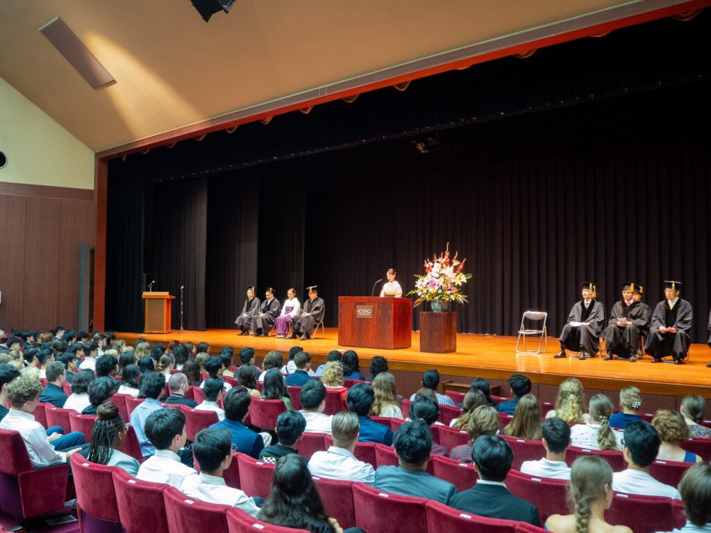 Yamanashi Gakuin University's President Takako Aoyama gives her welcome speech to new students at the Memorial Hall.