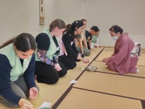 iCLA students sit in front of the tea ceremony instructor to practice ceremony etiquette.