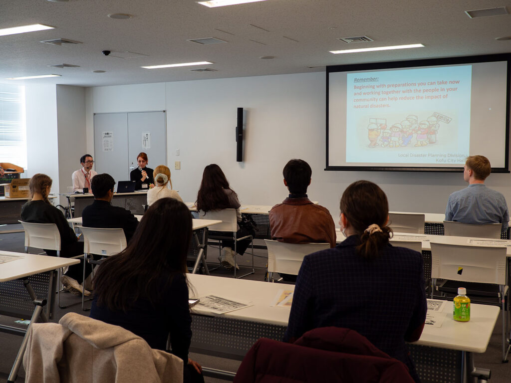 iCLA students sit in a lecture room in Kofu City Hall to learn about disaster preparation.